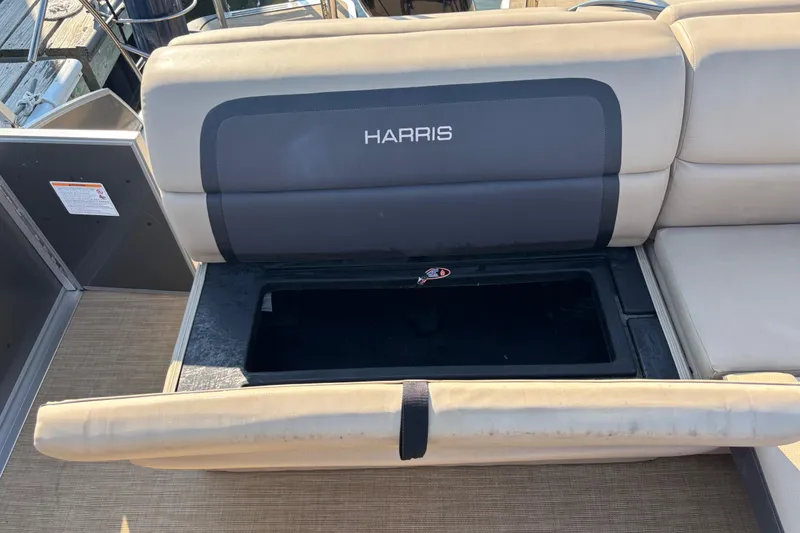 Slide: The Image of 2024 Harris HCX23 boat seat with open storage compartment, beige upholstery. - 8