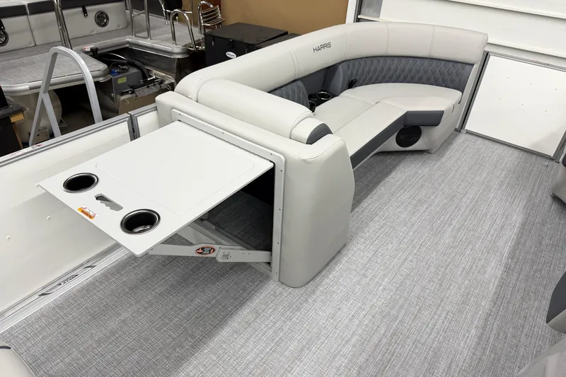 Slide: The Image of 2026 Harris Cruiser 230 interior with gray seating and foldable table. - 12