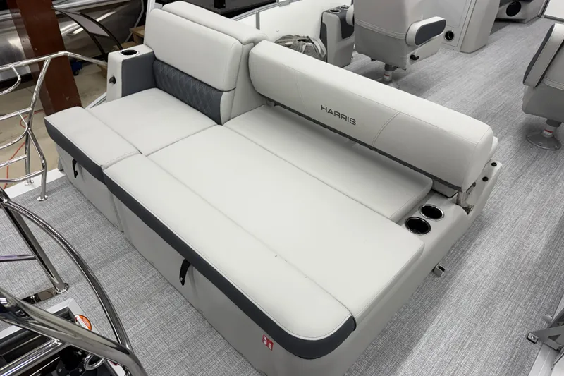 Slide: The Image of 2026 Harris Cruiser 230 boat interior with gray seating and cup holders. - 9