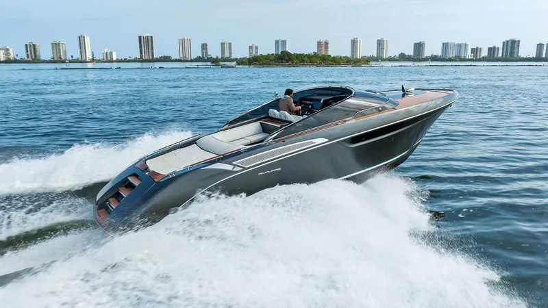 Slide: The Image of 2017 Riva Rivamare luxury yacht cruising on open water with city skyline in background. - 6