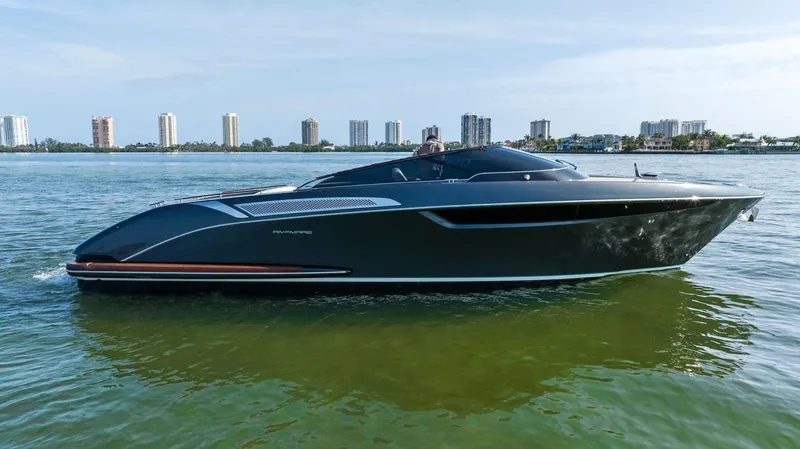 Slide: The Image of 2017 Riva Rivamare luxury yacht cruising on calm waters with city skyline in the background. - 8