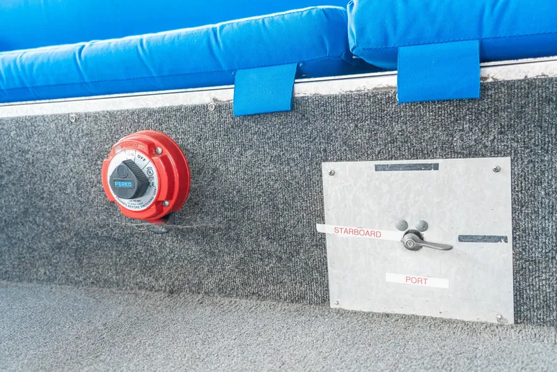 Slide: The Image of Pontoon boat interior with red control knob and labeled switch panel, blue seating. - 28