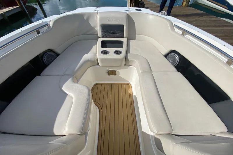 Slide: The Image of 2019 Boston Whaler 270 Vantage boat interior with cushioned seating and cup holders. - 18