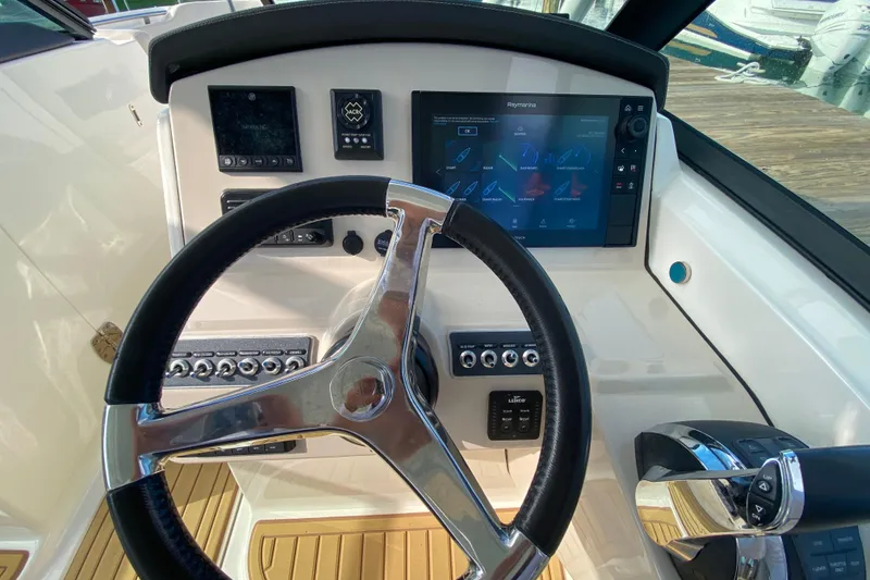 Slide: The Image of Steering console of 2019 Boston Whaler 270 Vantage with modern navigation controls. - 21