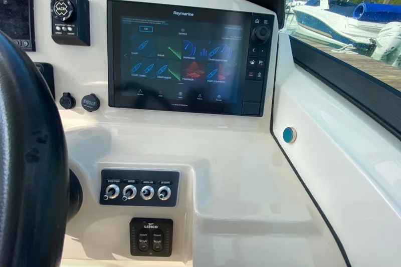 Slide: The Image of 2019 Boston Whaler 270 Vantage dashboard with Raymarine navigation system and control panel. - 22