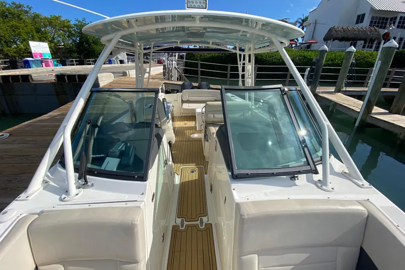 Slide: The Image of 2019 Boston Whaler 270 Vantage boat docked, featuring spacious seating and sleek design. - 30