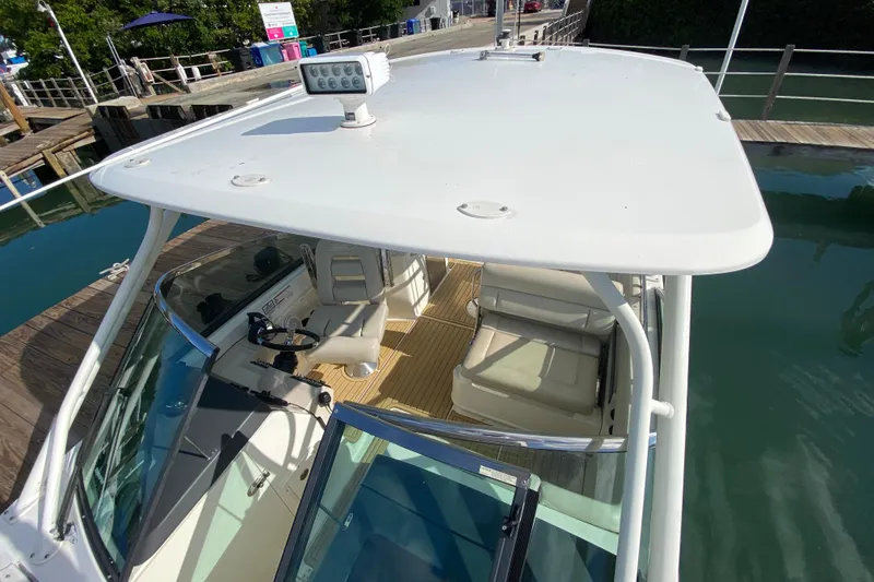 Slide: The Image of 2019 Boston Whaler 270 Vantage boat docked, featuring spacious seating and modern design. - 32