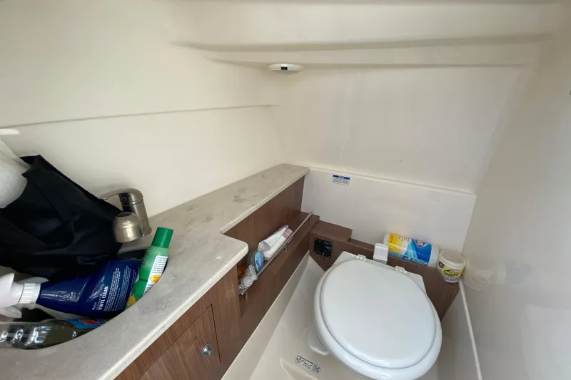 Slide: The Image of 2019 Boston Whaler 270 Vantage boat interior with toilet and storage area. - 39