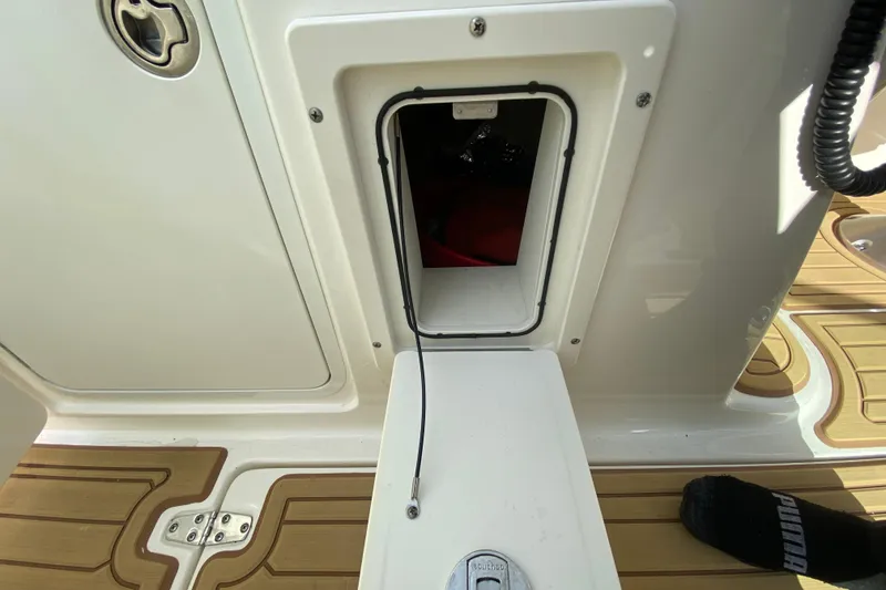 Slide: The Image of 2019 Boston Whaler 270 Vantage storage compartment with teak flooring detail. - 41