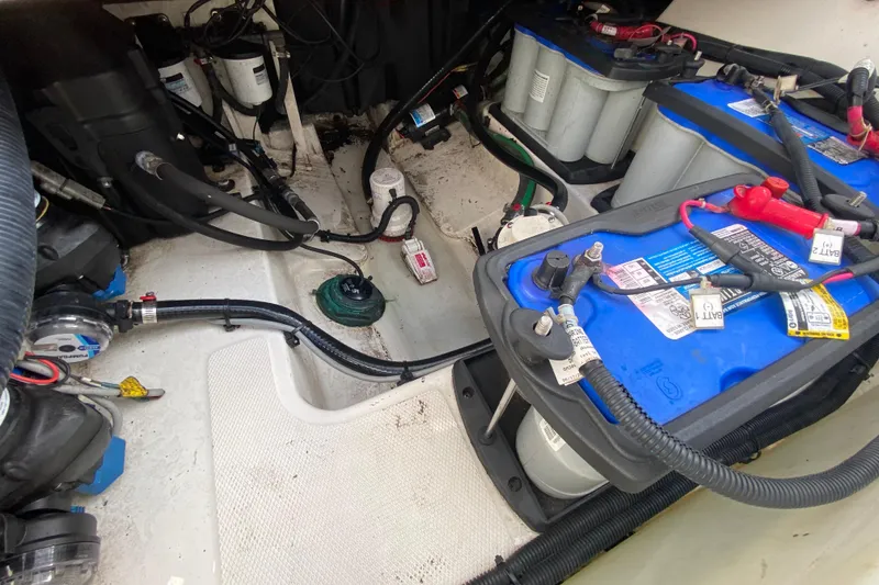 Slide: The Image of 2019 Boston Whaler 270 Vantage engine compartment with batteries and wiring. - 48