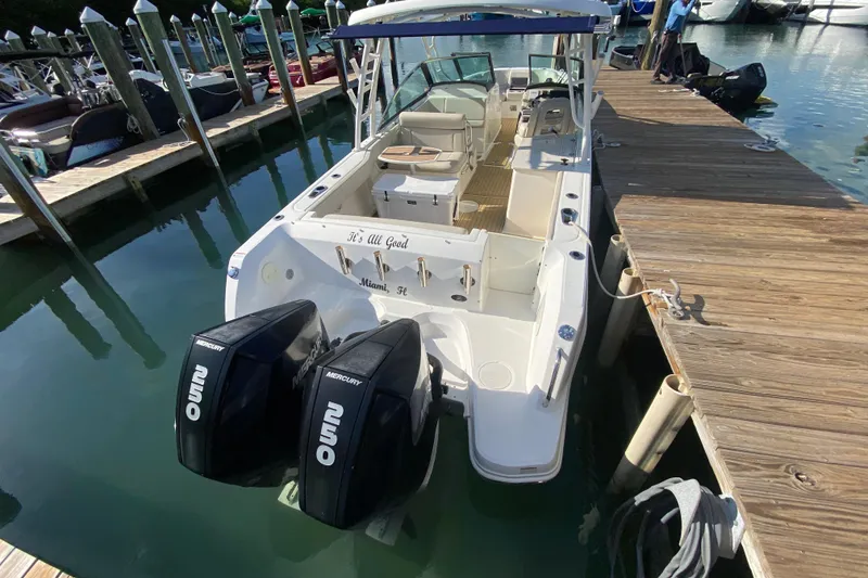 Slide: The Image of 2019 Boston Whaler 270 Vantage docked, featuring dual Mercury outboard engines. - 54