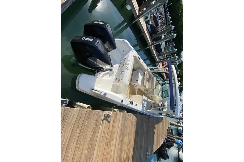 Slide: The Image of 2019 Boston Whaler 270 Vantage docked with dual engines, viewed from above. - 55