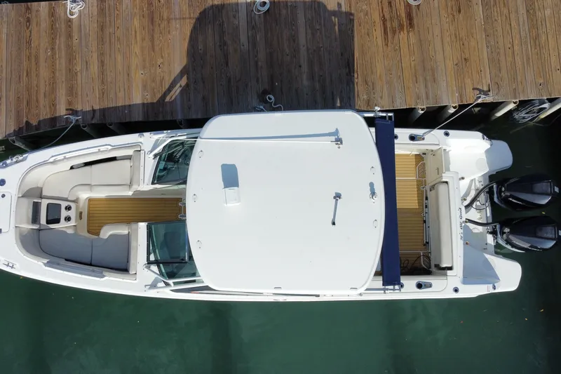 Slide: The Image of Overhead view of a 2019 Boston Whaler 270 Vantage docked at a wooden pier. - 56