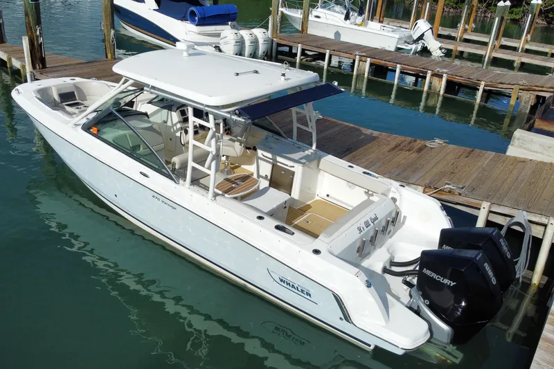 Slide: The Image of 2019 Boston Whaler 270 Vantage boat docked with dual Mercury engines. - 59