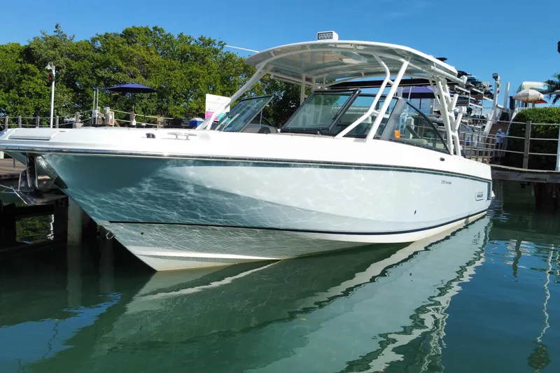 Slide: The Image of 2019 Boston Whaler 270 Vantage boat docked on calm water. - 7