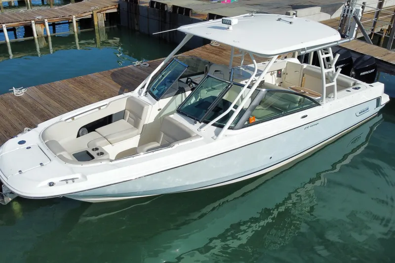 Slide: The Image of 2019 Boston Whaler 270 Vantage boat docked in clear water. - 8