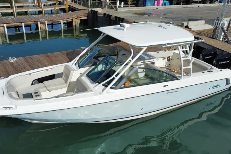 Slide: The Image of 2019 Boston Whaler 270 Vantage boat docked at marina, featuring sleek design and spacious seating. - 9