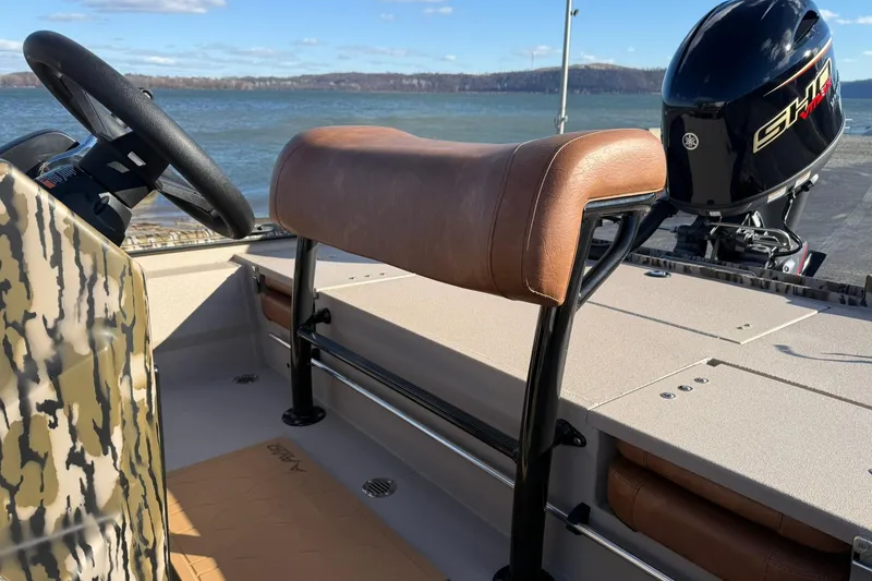 Slide: The Image of 2026 Avid 20 ROGUE CC boat interior with steering wheel and Yamaha engine. - 10