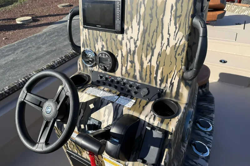 Slide: The Image of Avid 20 ROGUE CC 2026 boat console with steering wheel and controls. - 13