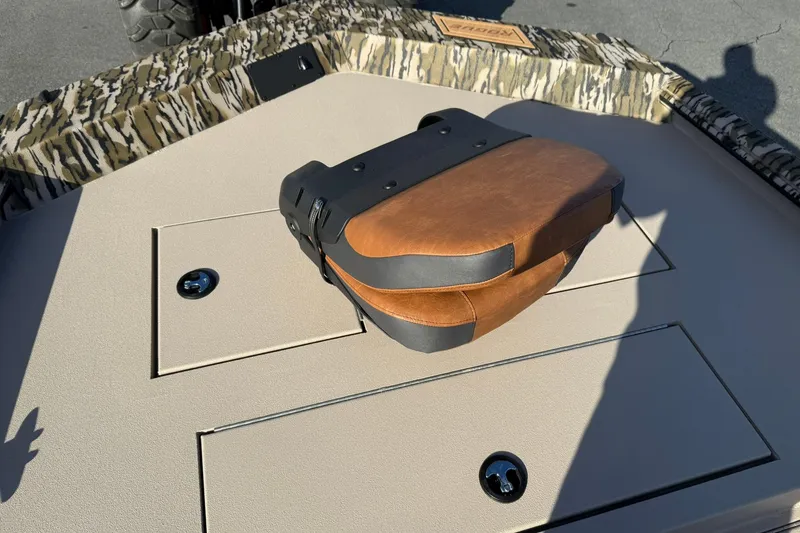 Slide: The Image of 2026 Avid 20 ROGUE CC boat deck with camo trim and brown seat cushion. - 17