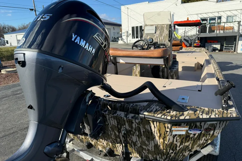 Slide: The Image of 2026 Avid 20 ROGUE CC boat with Yamaha motor, camo design, and Garmin equipment. - 5