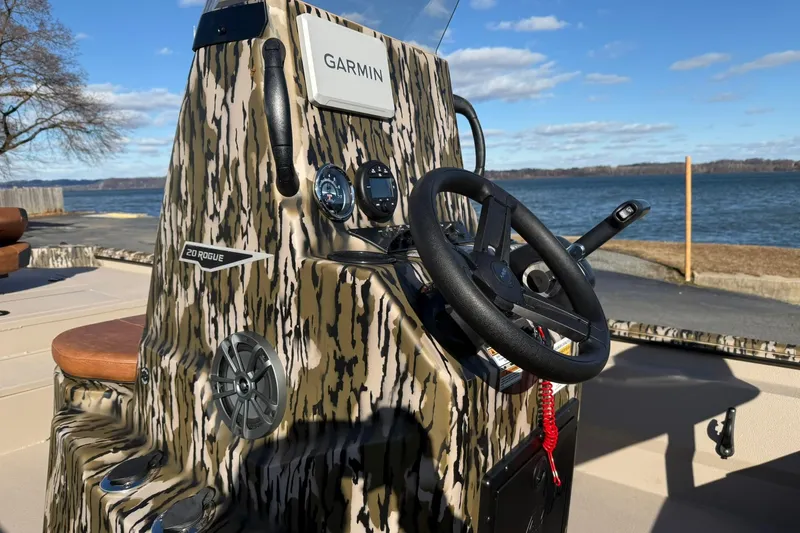 Slide: The Image of 2026 Avid 20 ROGUE CC boat console with Garmin system, near scenic waterfront. - 8