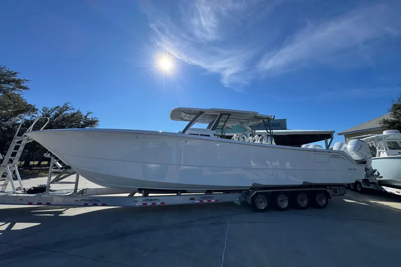 The Image of 2026 Invincible 46 Catamaran on trailer under bright sun, showcasing sleek design. - 1