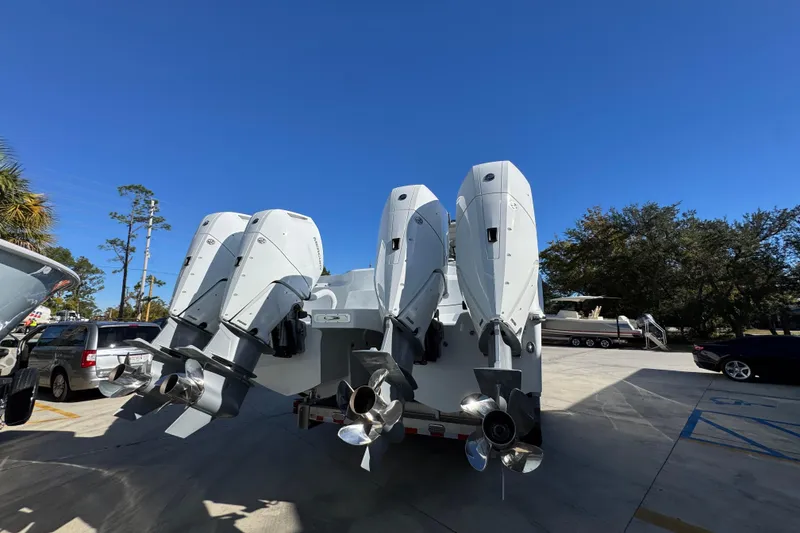 Slide: The Image of 2026 Invincible 46 Catamaran with four powerful outboard engines, parked outdoors. - 15