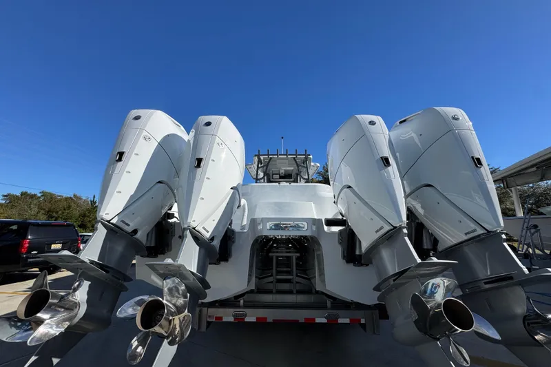 Slide: The Image of 2026 Invincible 46 Catamaran with four powerful outboard engines, rear view. - 16