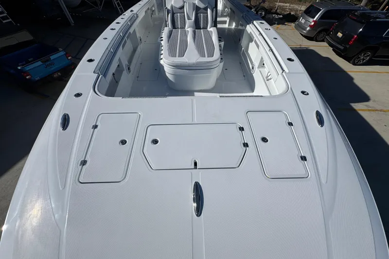 Slide: The Image of 2026 Invincible 46 Catamaran deck view, showcasing spacious seating and storage compartments. - 19