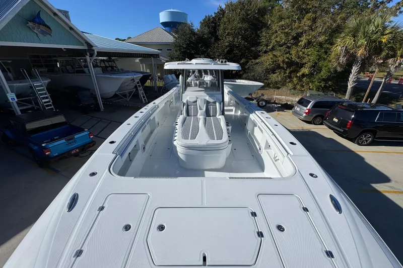 Slide: The Image of 2026 Invincible 46 Catamaran docked, showcasing spacious deck and seating area. - 20