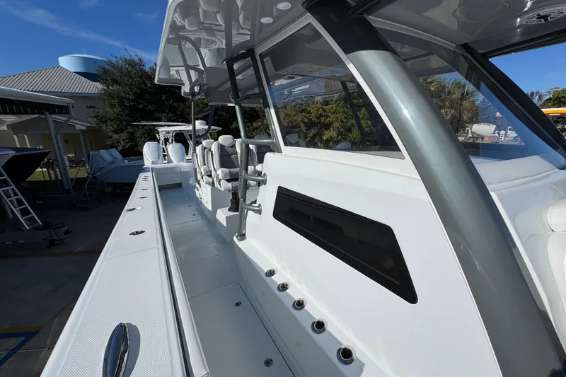 Slide: The Image of 2026 Invincible 46 Catamaran, sleek design, docked under clear blue sky. - 24