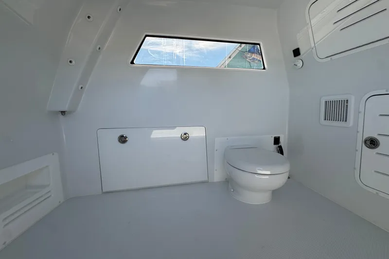 Slide: The Image of Interior of 2026 Invincible 46 Catamaran bathroom with modern fixtures and window. - 30