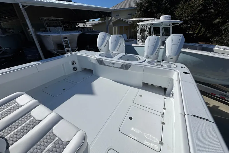 Slide: The Image of 2026 Invincible 46 Catamaran with spacious deck and modern seating in a marina setting. - 46