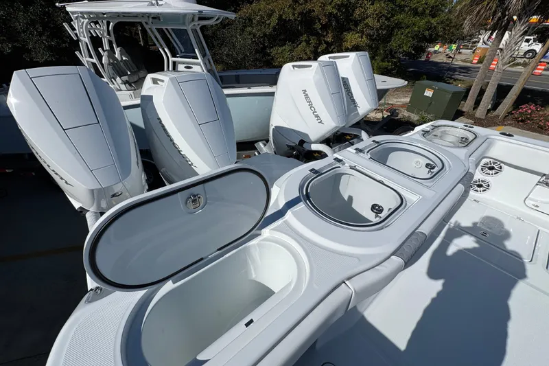 Slide: The Image of 2026 Invincible 46 Catamaran with Mercury outboard engines and open storage compartments. - 50