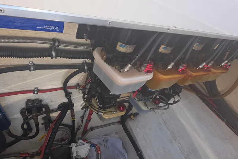 Slide: The Image of Engine compartment of a 1992 Fountain boat with fuel filters and hoses. - 12