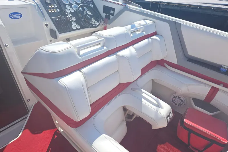 Slide: The Image of Interior of a 1992 Fountain boat with white and red seating and control panel. - 13