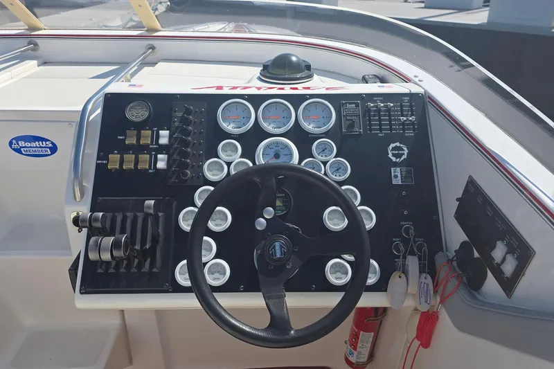 Slide: The Image of 1992 Fountain boat dashboard with steering wheel, gauges, and control switches. - 14