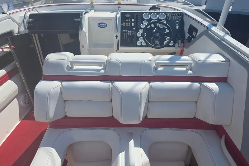 Slide: The Image of Interior of a 1992 Fountain boat with white and red seating, and a detailed dashboard. - 16