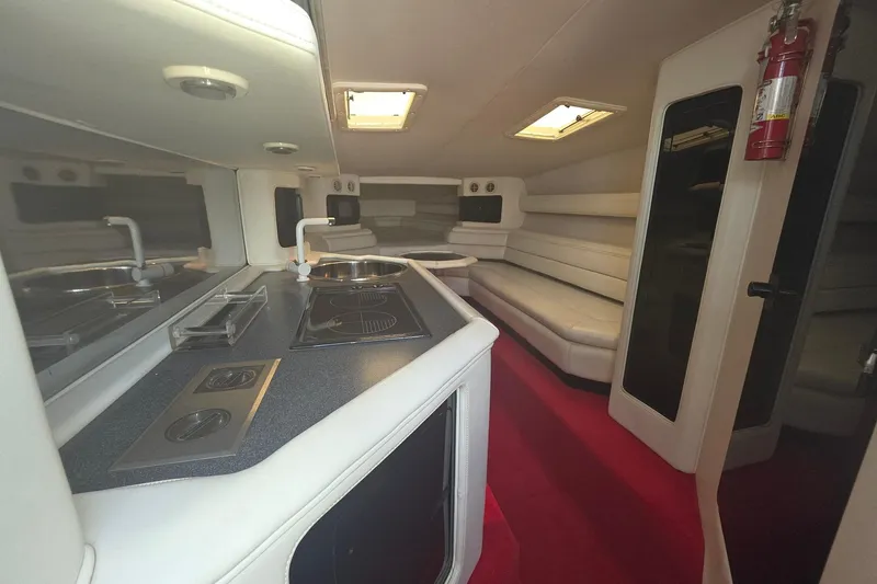 Slide: The Image of Interior of a 1992 Fountain boat with kitchen and seating area. - 18