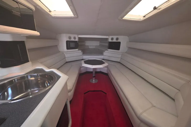 Slide: The Image of Luxurious 1992 Fountain boat interior with white seating, red carpet, and stainless steel sink. - 19