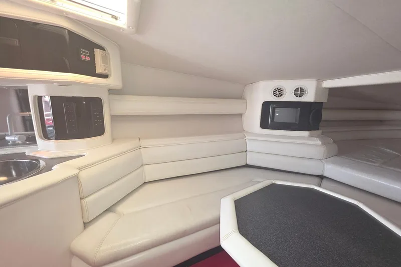 Slide: The Image of Interior of a 1992 Fountain boat with white seating and modern amenities. - 22