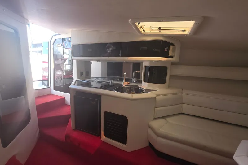 Slide: The Image of Interior of a 1992 Fountain boat with kitchenette and seating area. - 23