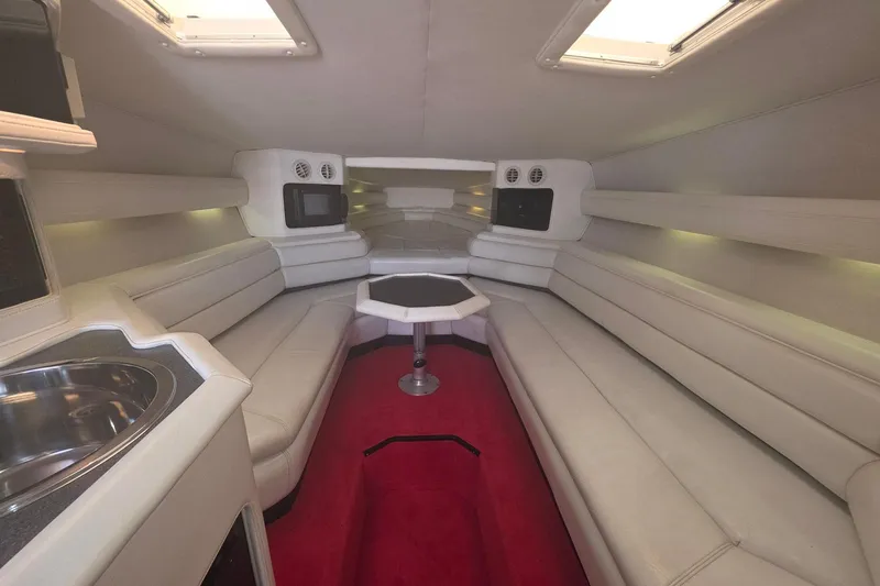Slide: The Image of Luxurious 1992 Fountain boat interior with white seating, red carpet, and modern amenities. - 24
