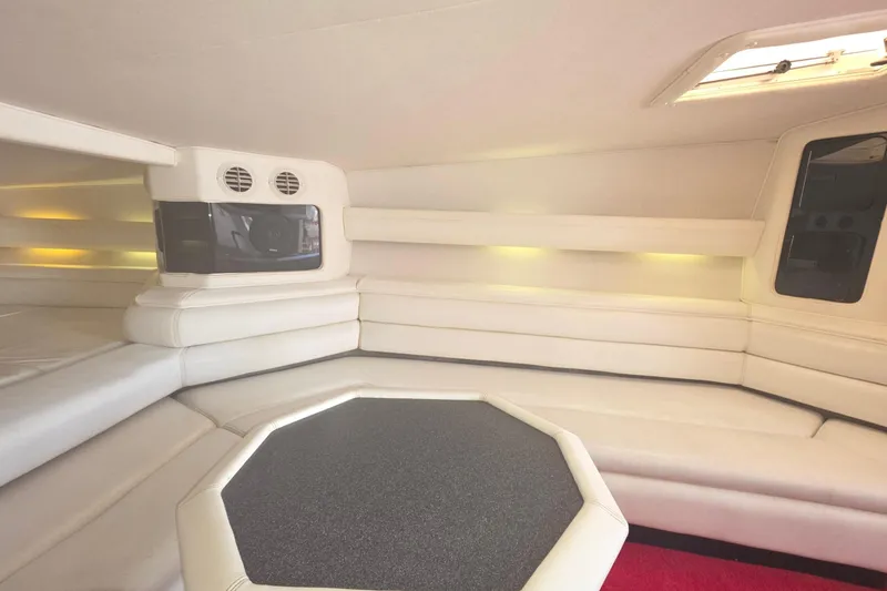 Slide: The Image of Interior of a 1992 Fountain boat with white seating and modern design. - 26