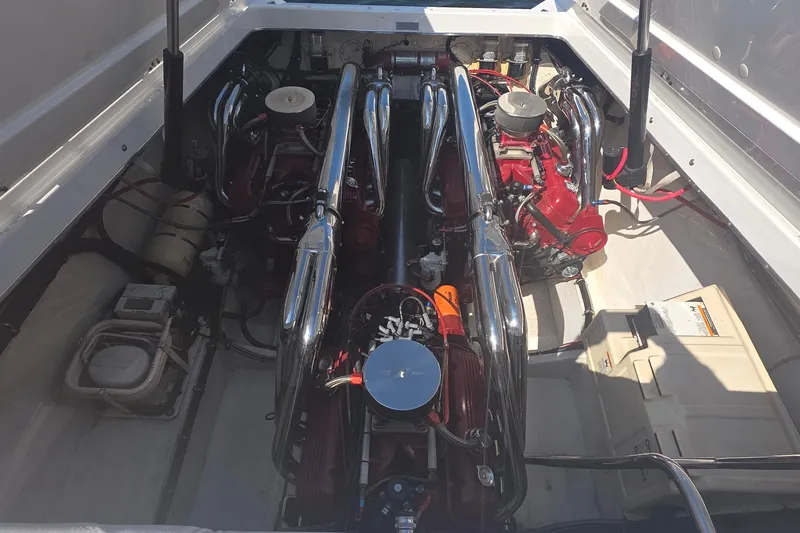 Slide: The Image of Engine compartment of a 1992 Fountain boat with dual engines and chrome exhausts. - 3