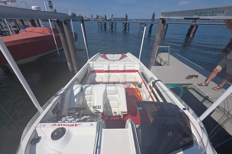 Slide: The Image of 1992 Fountain boat docked, featuring white and red interior, with clear blue water background. - 31