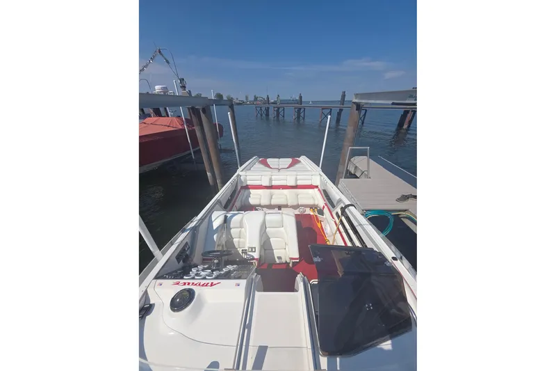 Slide: The Image of 1992 Fountain boat docked, featuring white seating and red accents under a clear blue sky. - 32