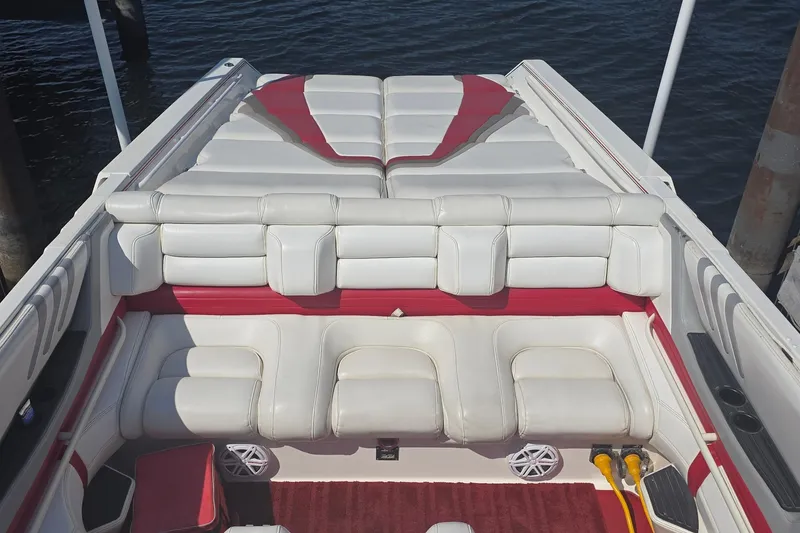 Slide: The Image of Interior of a 1992 Fountain boat with white and red seating, docked by water. - 33