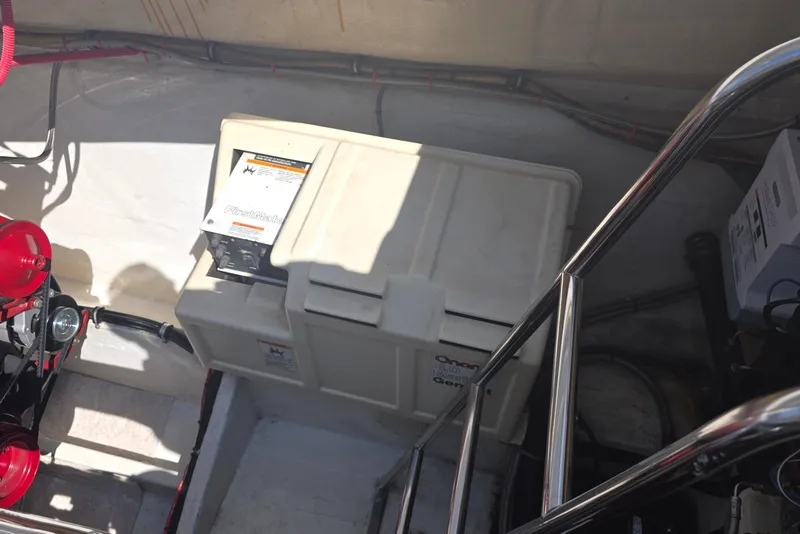 Slide: The Image of 1992 Fountain boat engine compartment with Onan generator and wiring. - 5